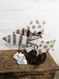 Four White Fish On Driftwood
