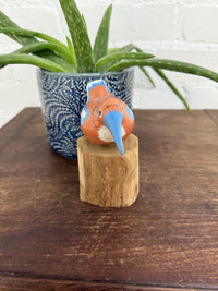 Orange Bird On Driftwood Stand